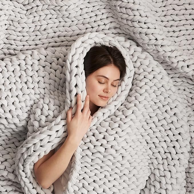 Bearaby hand-knit cotton weighted blanket in moonstone grey, showing the chunky open-knit structure.